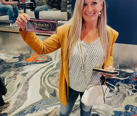 Guest holds free play giveaway certificate.
