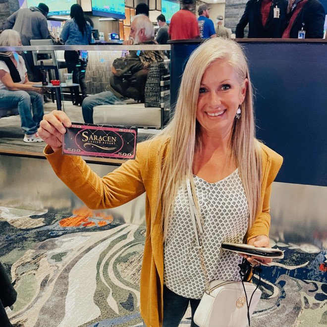 Guest holds free play giveaway certificate.