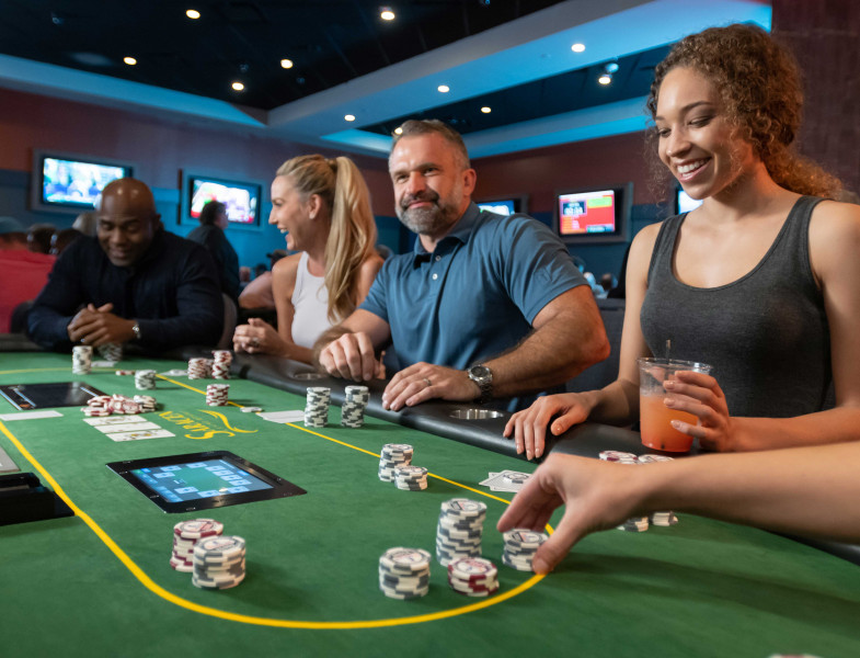 guests sitting at the poker table at Saracen Casino Resort in Pine bluff