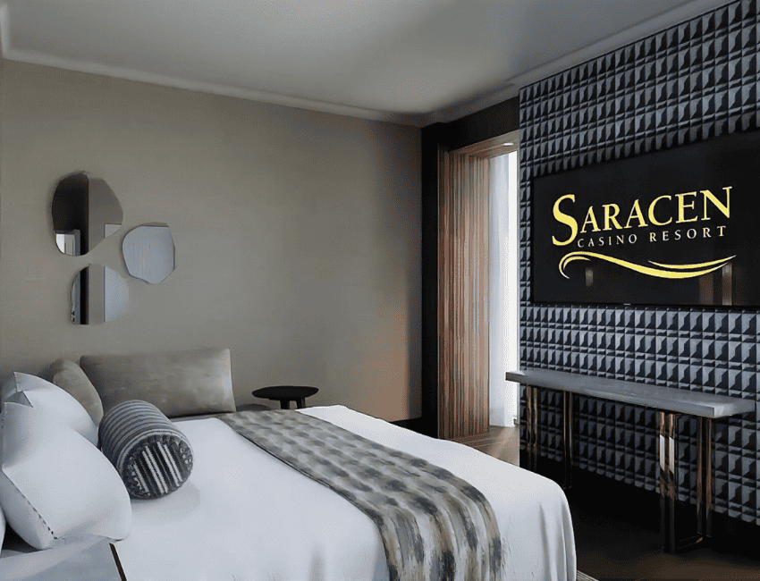 Modern hotel room with a large bed, geometric accent wall, and a lit 